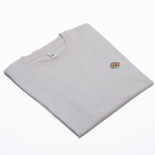 Oatmeal organic cotton unisex t-shirt with embroidered HIGGS dog logo on the chest.