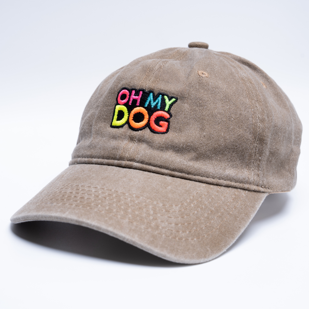 Beige cap with 'OH MY DOG' text in colorful letters on a white background