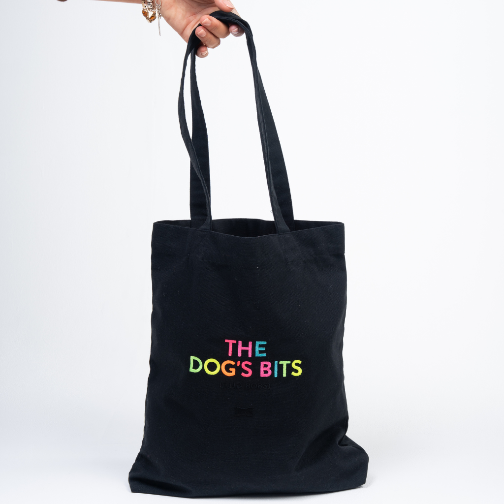 Hand holding The Dog's Bits Daycare Bag